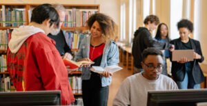 College students chat in a library