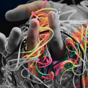 A handful of tangled plastic cords. Gifted people with ADHD