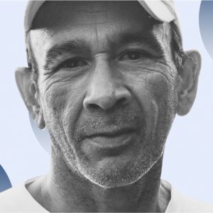 Older man in a baseball cap against a blue background. Recovery after 50