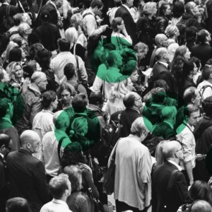 Black & white photo of a crowd of people with green dots over several individuals. Recovery is different for everyone.