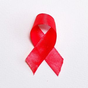 Red awareness ribbon. Fighting stigma on World AIDS Day