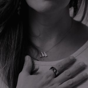 Closeup of Syd Rhodes with her hand on her chest. Breathwork is a bridge