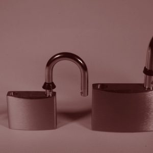 Three padlocks in graduated sizes, their hasps in the unlocked position. Smart, sober, and getting scammed.