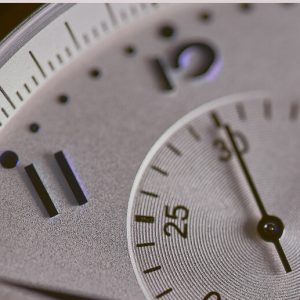 Closeup on a watch face showing the second hand.