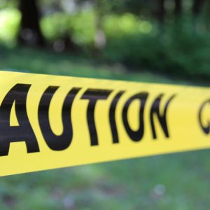 Yellow CAUTION tape blocking an outdoor area