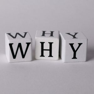 Cubes with letters on them spell out the word Why