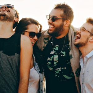 A group of four friends laugh together.