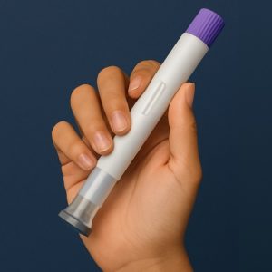 Hand holding a medication injector pen