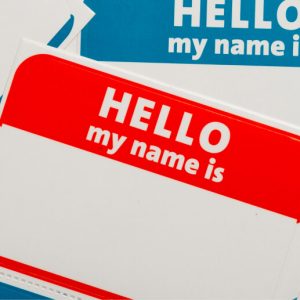 Blank adhesive name tags in red and blue, with the words "Hello my name is" printed on them.