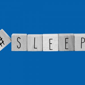 Wooden block spelling out #sleep. Sleeping in recovery