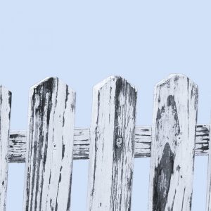 Wooden picket fence against a pale blue background. Boundaries are a gift