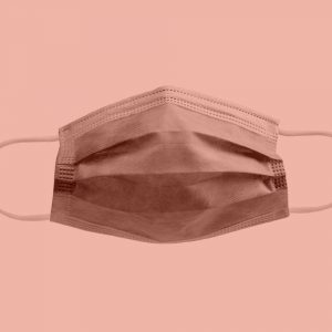 Disposable face mask on a peach background