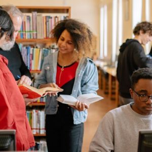 College students chat in a library
