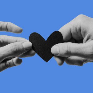 Two hands holding a paper heart. Dating in recovery