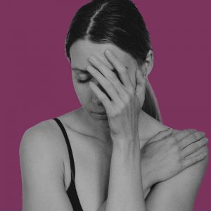 Self-medicating depression. Distressed woman with her hand over her face.