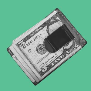 Money clip on green background. What does it mean to be financially sober?