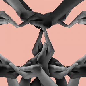 Many people holding their hands together to form two hearts. How I found my people.