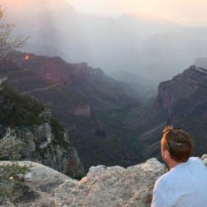 Kip Shubert, founder of Warriors on Purpose, sits on a mountain looking at the sunrise