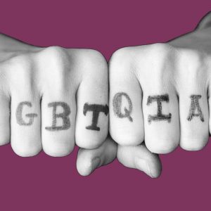 Hands with LGBTQIA+ written across the knuckles
