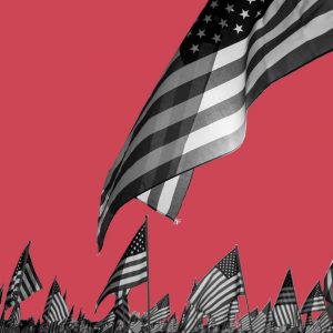 Many American flags against a red background. Ways to celebrate Memorial Day sober.