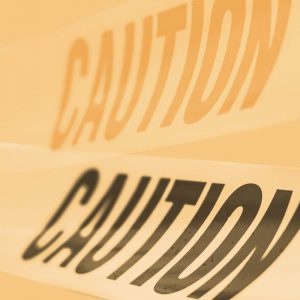 Caution tape on a yellow backdrop. The dangers of buying naltrexone without a prescription