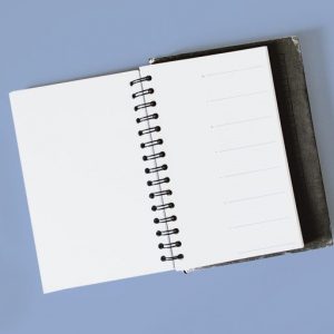 Blank journal on a blue background. Gratitude lists