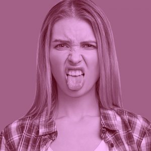 Woman making a disgusted face with her tongue sticking out. Suboxone tastes bad.