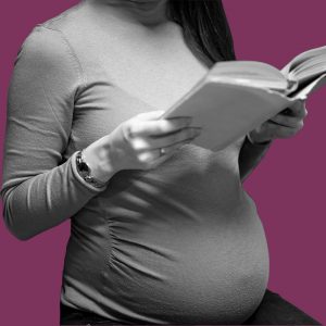 Pregnant woman reading a book. Medically-assisted treatment for opioids during pregnancy