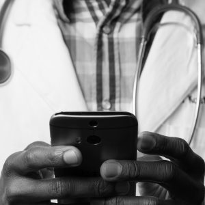 Telemedicine key terms. Doctor using a smartphone.