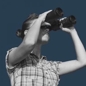 Woman with binoculars. looking for addiction treatment