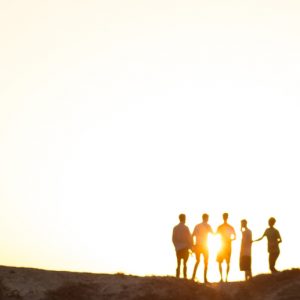 Silhouettes of a group against the setting sun. When I knew I was an alcoholic.