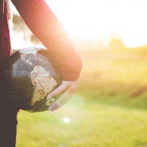 person-holding-globe