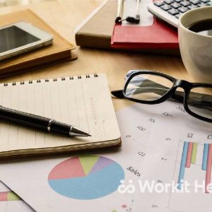 A cluttered desk with pie charts and work items.