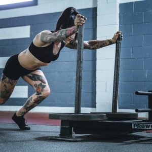 woman-pushing-weighted-sled