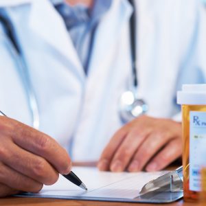 A doctor writes a prescription. Buprenorphine saves lives.