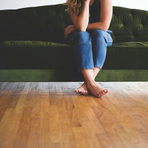 woman-sitting-on-green-couch